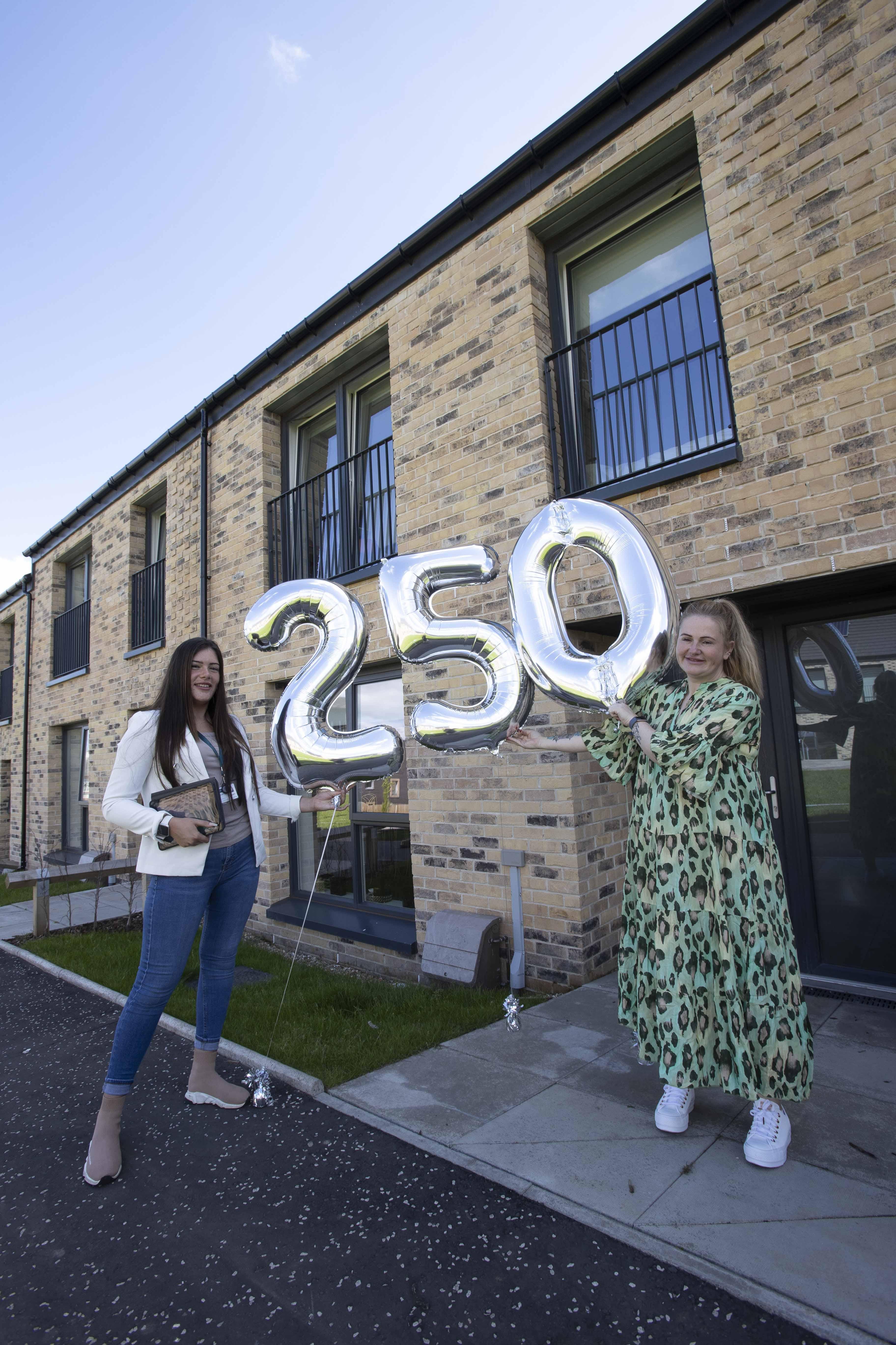 Lowther agent and tenant at Craigmillar with 250th balloons
