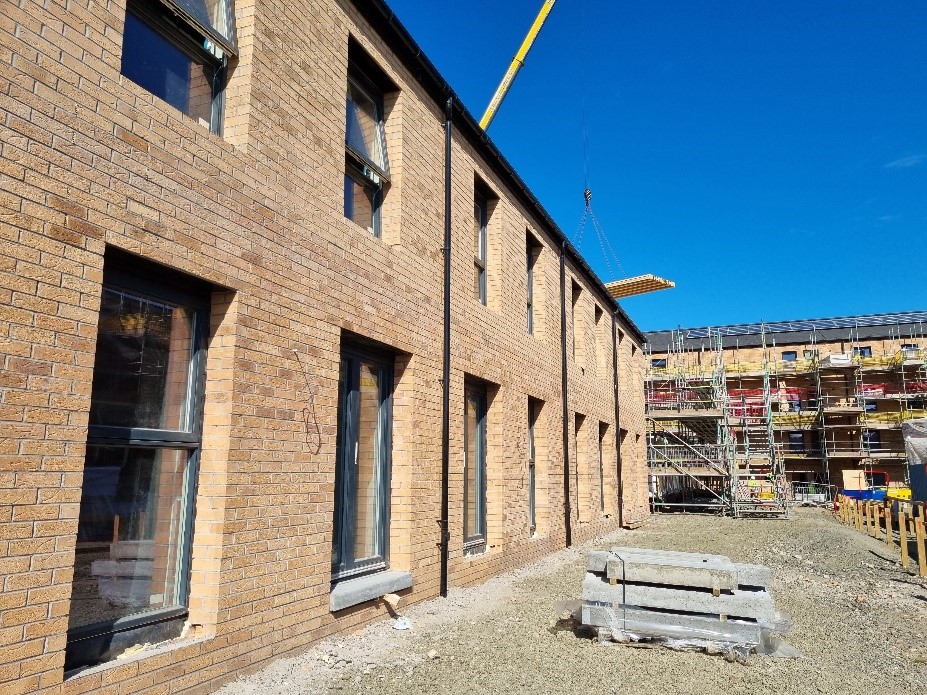 A row of houses at Pennywell with a row behind still under construction